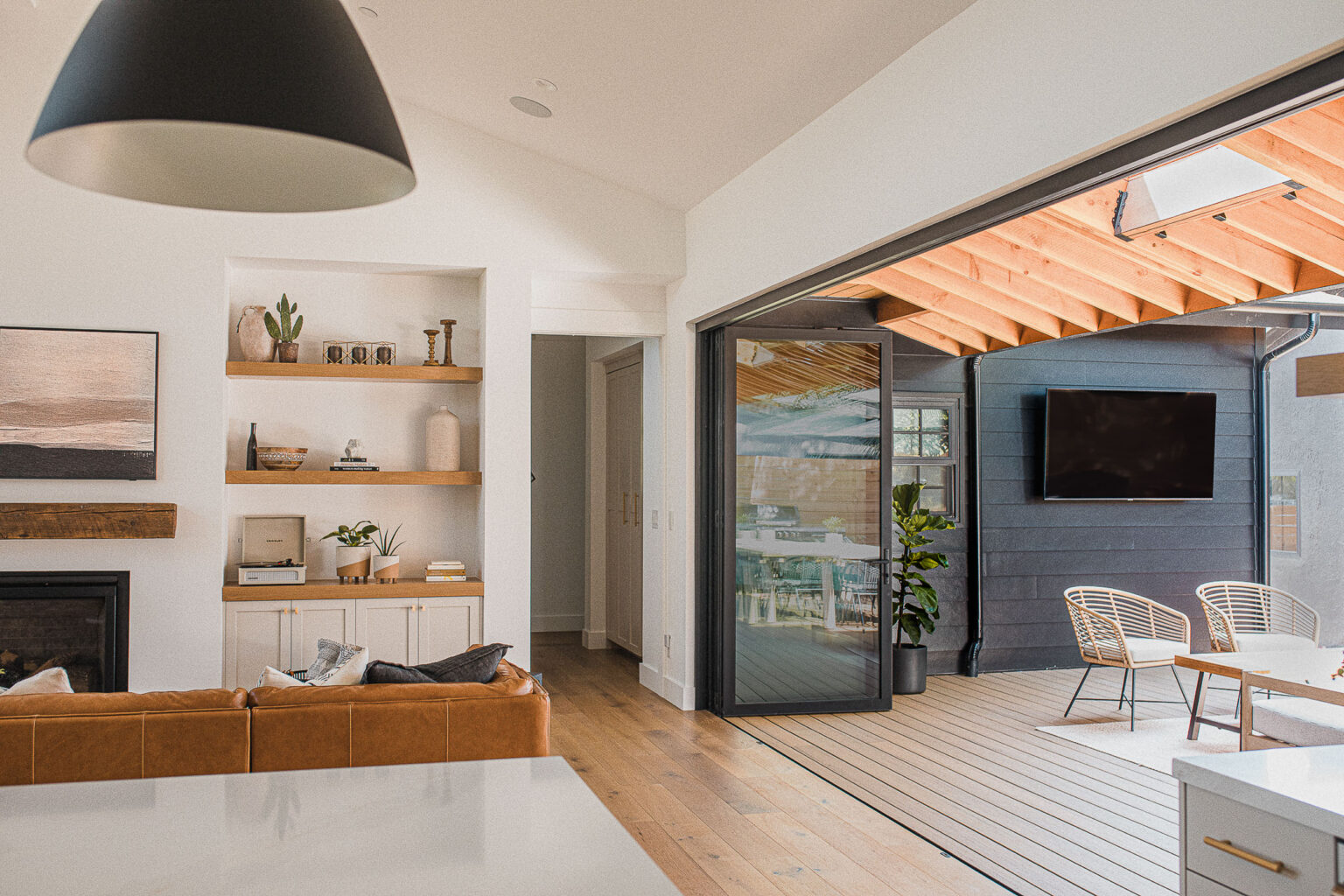 The living room with the La Cantina door folded open to the deck