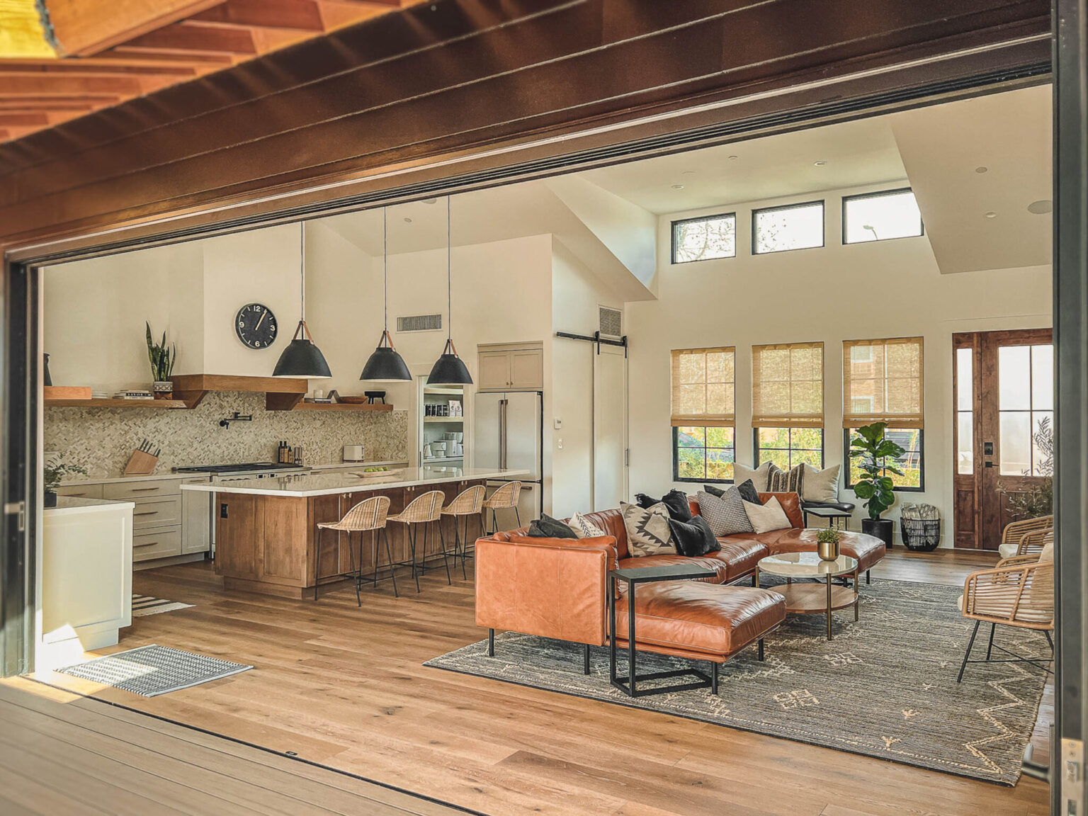 The great room, looking across the sofa to the kitchen island