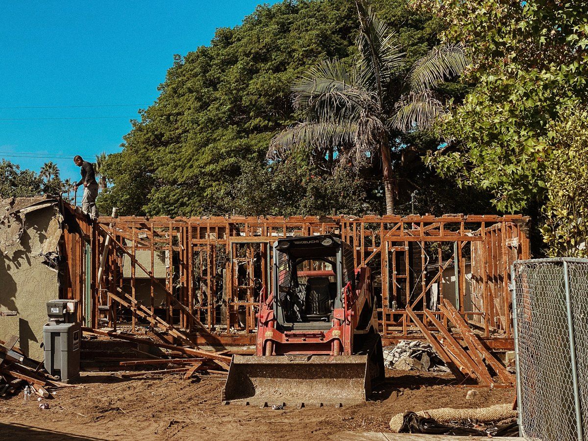 The house mid-demolition, stripped back to its original framing